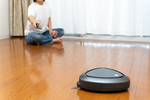 Japanese woman using robotic cleaner app