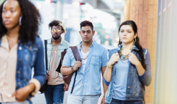 istock Multi-ethnic young adults walking in the city, strangers 1203843316