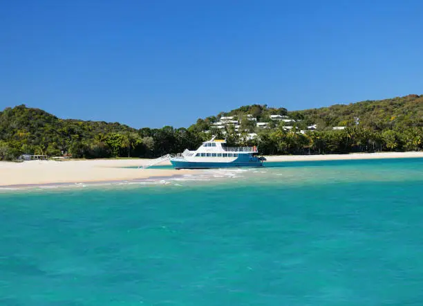 Boat In The Turquoise Water Of The Tropical Bay Of Great Keppel Island On A Sunny Day With Clear Blue Sky