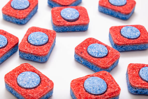 istock Many red and blue dishwasher soap tablets on white background, kitchen equipment and solutions for washing dishes 1203845652