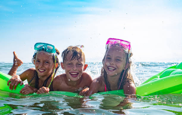 istock Children in the sea 1203847743