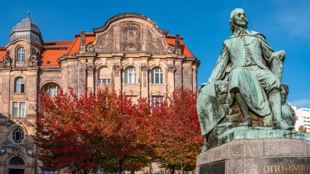Photo of Statue of great scientist Otto Guericke in Magdeburg in red and golden Autumn colors, Germany
