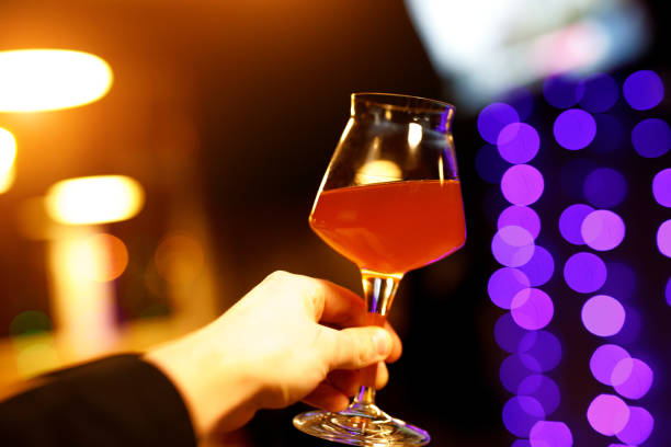 istock Beer glass with a thin leg in hand. 1203852358
