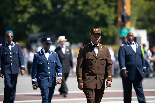 Chicago, Illinois, USA - August 8, 2019: The Bud Billiken Parade, Members of the Nation of Islam, wearing uniforms, marching down the street at the parade