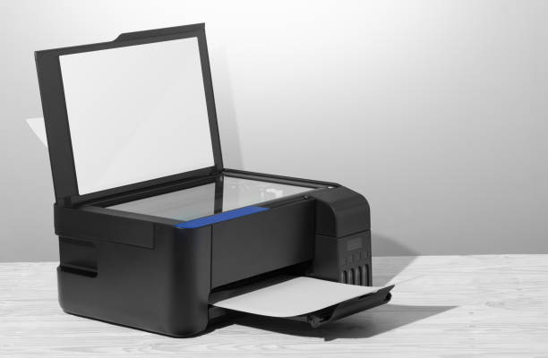 istock Black copier on white wooden table, closeup. 1203852602
