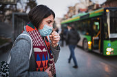Woman Wear Face Mask And Coughing While Standing In The Town