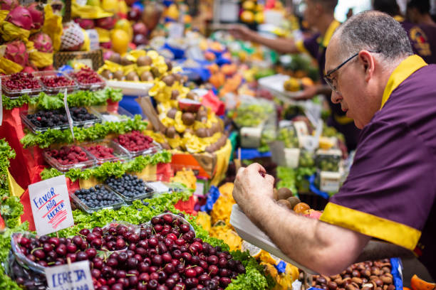 Fruit Stall São Paulo, SP, Brazil - February 01, 2020: Merchant at a fruit stall at the Municipal Market in the city center market hall stock pictures, royalty-free photos & images