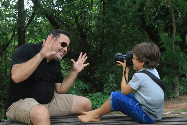 istock son records father's joy on park day 1203859489