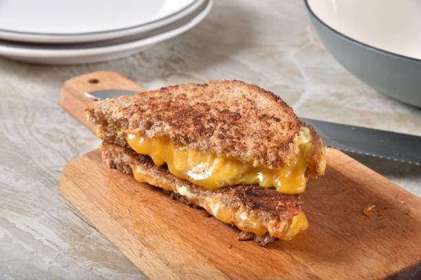 istock Sliced grilled cheese sandwich on a cutting board 1203859574