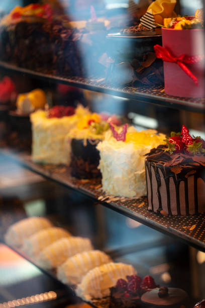 istock Different types of cakes in pastry shop glass display 1203862186