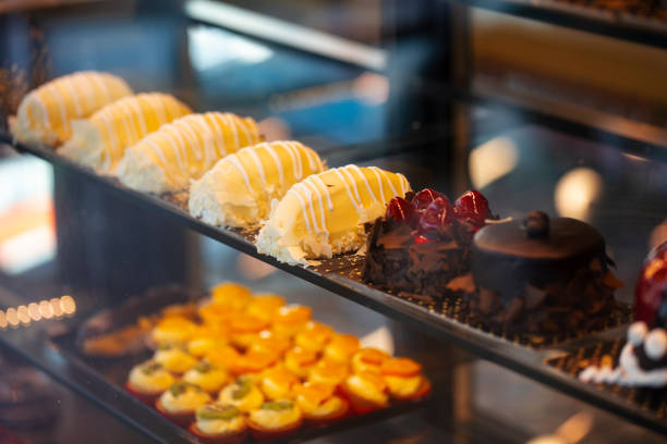 istock Different types of cakes in pastry shop glass display 1203862205
