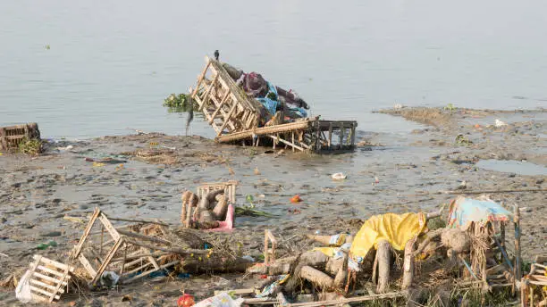 Ganges River Water Pollution the Polluted holy Ganga riverbank by religious rituals after Durga Puja Idol Immersions despite ban in place by National Green Tribunal Babughat Kolkata West Bengal India