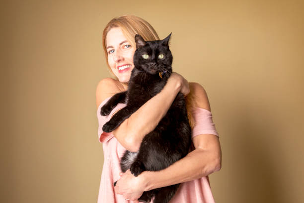 istock Woman Hugging Black Cat 1203864889