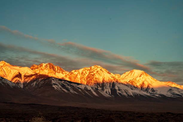 istock first morning sunlight illuminates snowy mountain peaks 1203865408