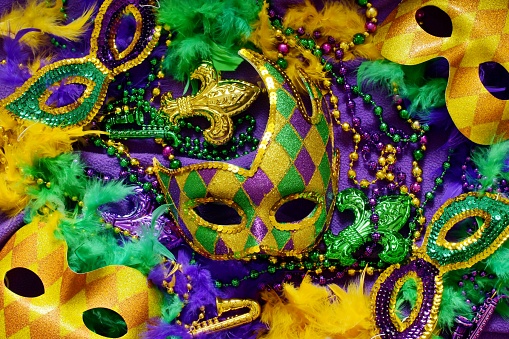 Colorful masks and decorations on a purple background