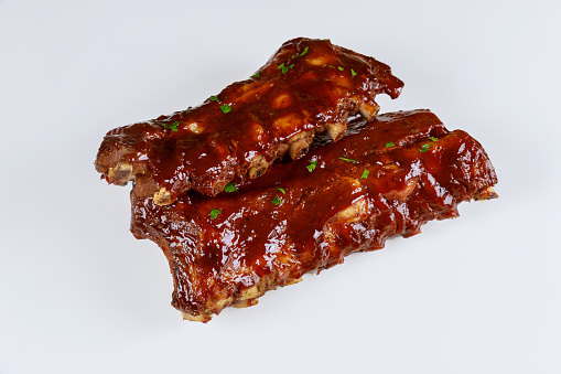 Hickory smoked barbecue beef ribs on isolated white background.