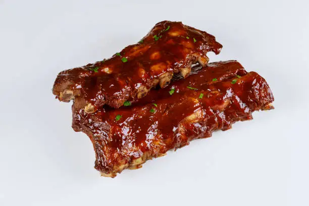 Photo of Hickory smoked beef ribs on isolated white background.