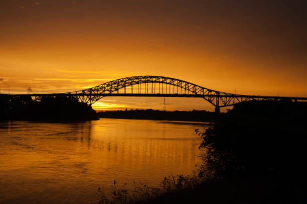 istock bridge with golden orange sky at sunset 1203880026