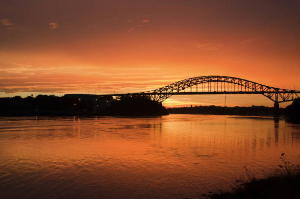 istock bridge with golden orange sky at sunset 1203880035