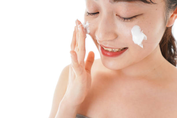 istock Young woman using cream to the face 1203883886