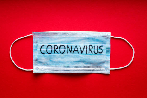 Coronavirus - 2019-nCoV, WUHAN virus concept. Surgical mask protective mask on red background. Chinese corona-virus outbreak.