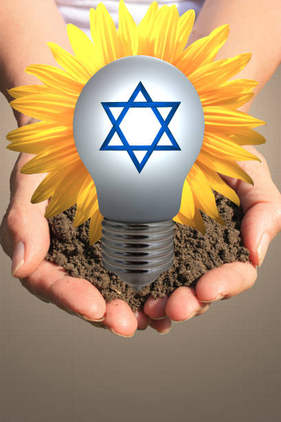 istock Judaism  Star of David  Solar energy  Hands lit by a light bulb 1203887548