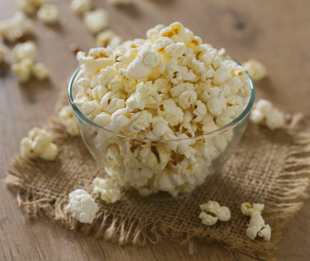 istock bowl of popcorn on wooden surface 1203887574