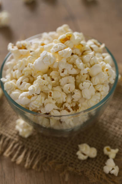 istock bowl of popcorn on wooden surface 1203887656