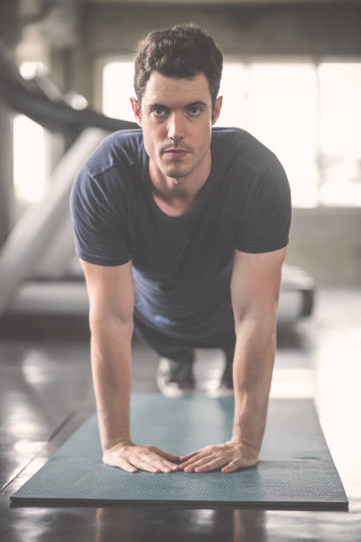 handsome man and strong guy doing push ups exercise in fitness gym - 16019 imagens e fotografias de stock