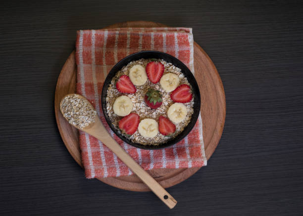 Aerial view of bowl with oatmeal and fruits stock photo