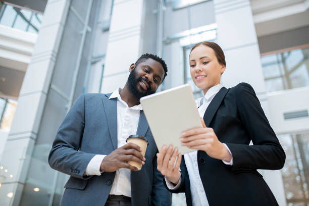 istock Discussing online report with colleague 1203895040