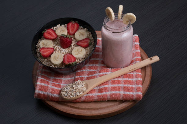 Banana strawberry and oatmeal smoothie with its ingredients stock photo