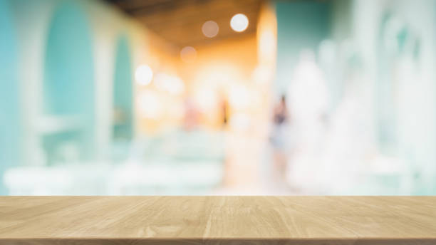 istock Empty wood table top and blur glass window interior restaurant banner mock up abstract background - can used for display or montage your products. 1203895317