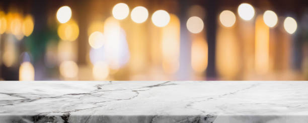 istock Empty white marble stone table top and blur glass window interior restaurant banner mock up abstract background - can used for display or montage your products. 1203895358