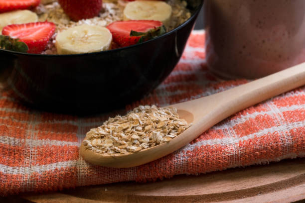 wooden spoon with oatmeal stock photo