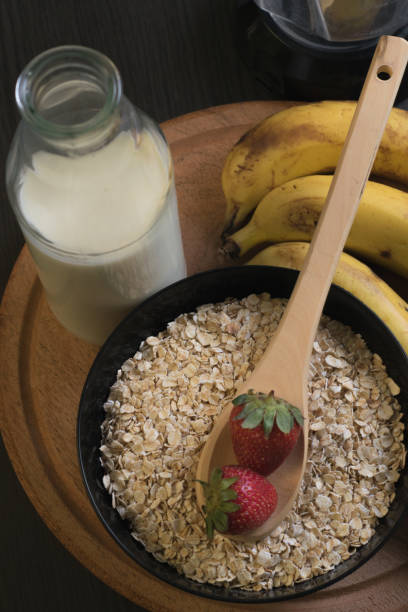 Strawberries oatmeal and bananas with a bottle of milk stock photo