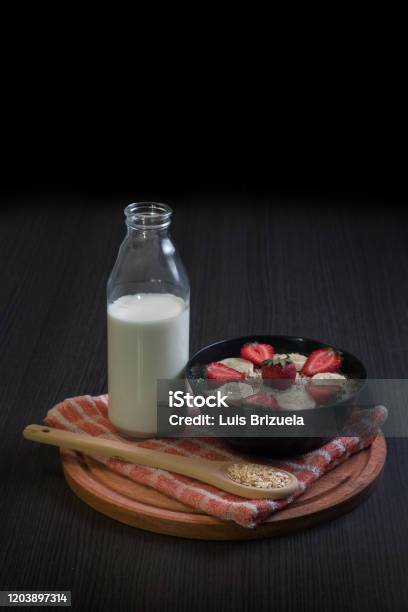 Bowl With Strawberry And Banana Oatmeal With A Bottle Of Milk Stock Photo - Download Image Now