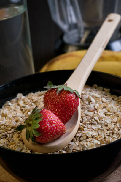 Strawberries oatmeal and bananas with a bottle of water stock photo