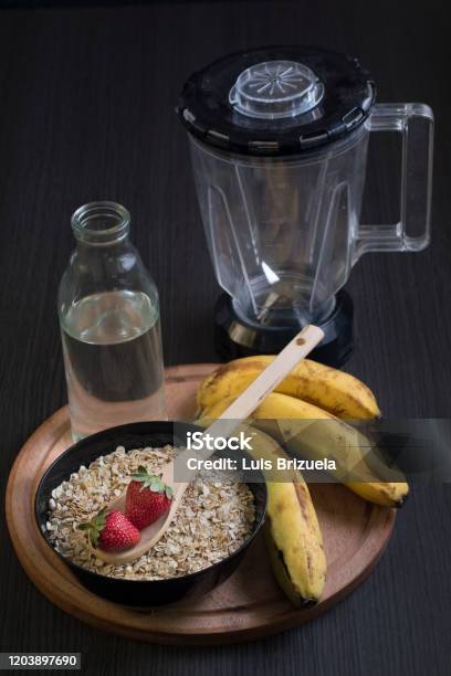 Strawberries Oatmeal And Bananas With A Bottle Of Water Stock Photo - Download Image Now