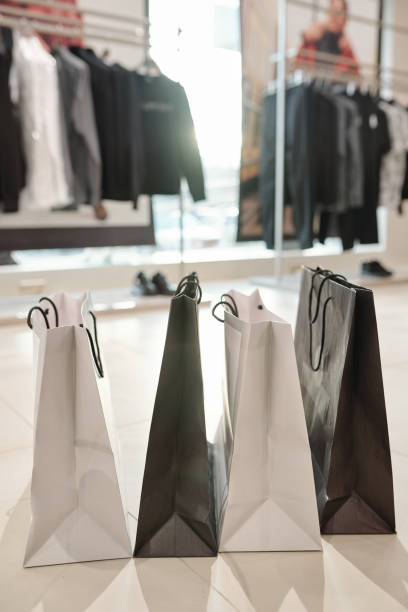 istock Black and white shopping bags on floor 1203900237