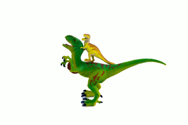 istock big green plastic toy dinosaur and small yellow dinosaur sitting on its back 1203900254