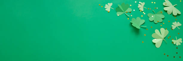 istock St. Patrick's day, clover on a green shiny background 1203900257