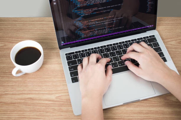 istock Web development, close-up images, a woman writing a program on a laptop screen. 1203900419
