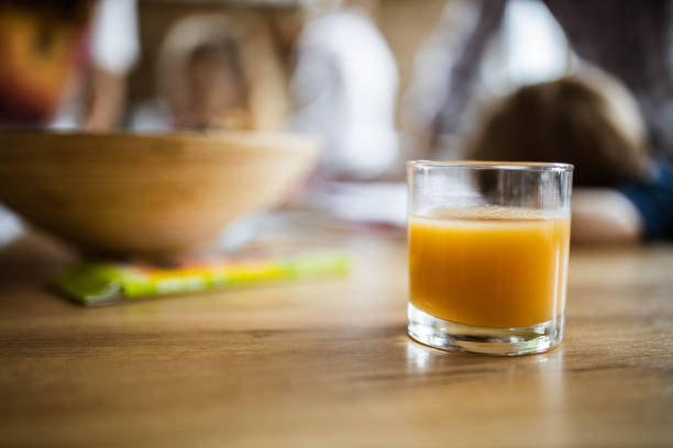 Close up of a glass of fresh orange juice on the table. Copy space.