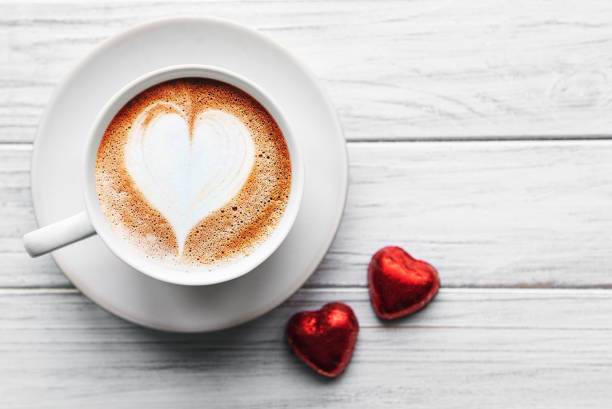 istock A cup of coffee with heart pattern on a table 1203903384