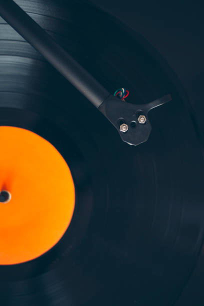istock Close up of turntable tonearm playing vinyl record 1203904082