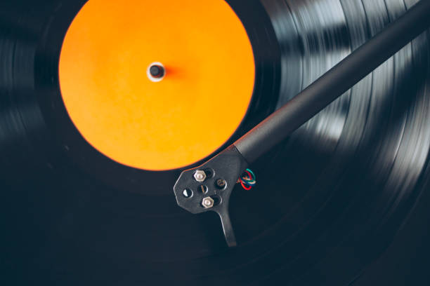 istock Close up of turntable tonearm playing vinyl record 1203904088
