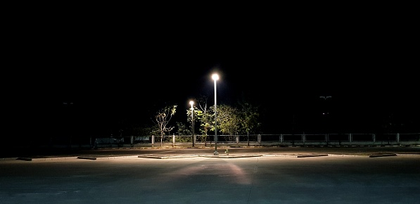 A lone lamppost luminates the parking lot.
