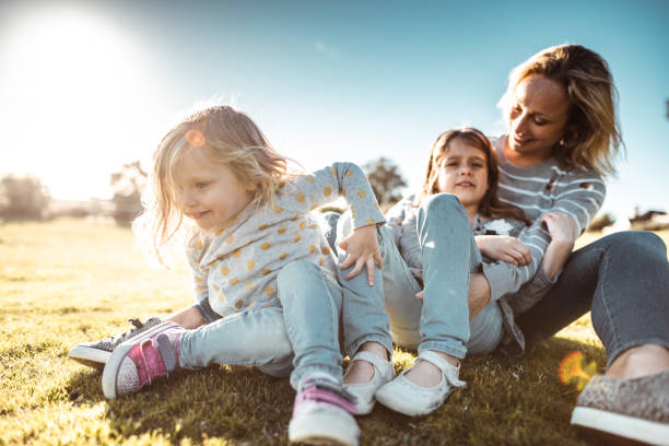 istock mother enjoy at the park with daughters 1203904545
