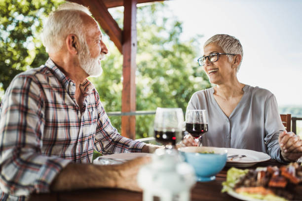 istock Happy senior couple talking during lunch on a terrace. 1203904605